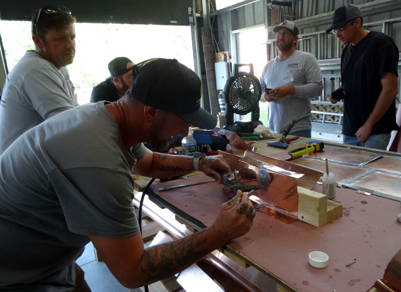 Solder copper flashings is taught at the Slate Roofing Contractors Association conference.