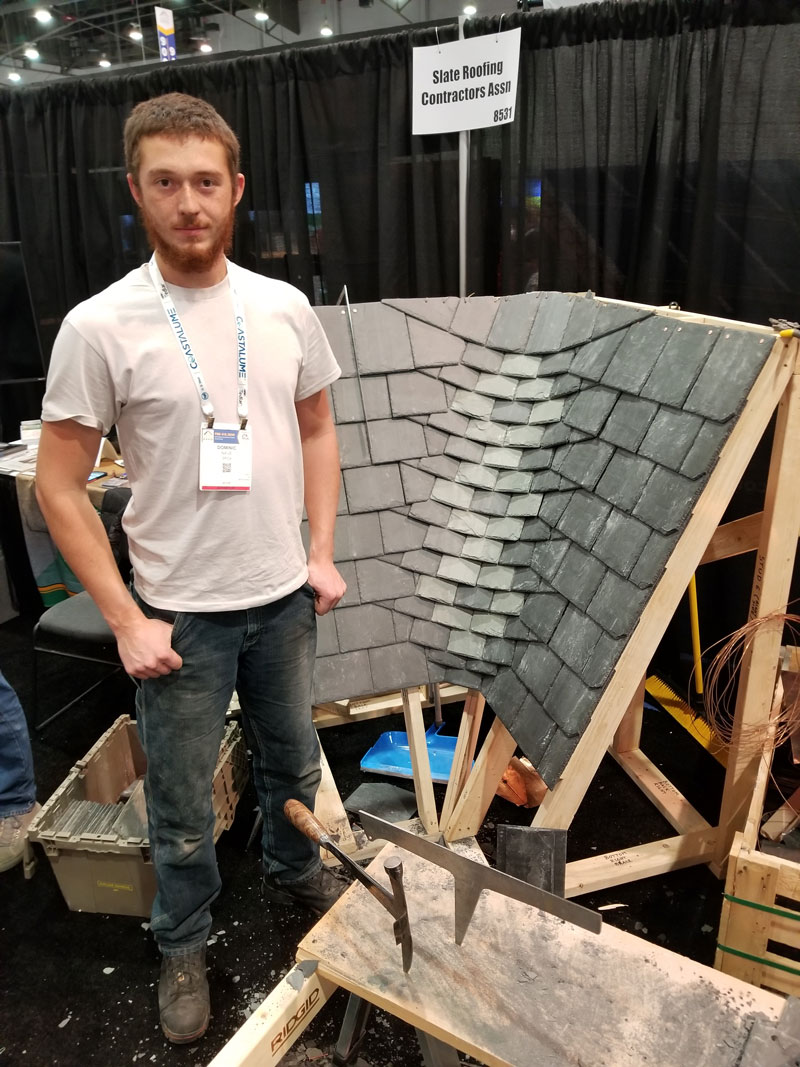 Dominic Nave of Jenkins Slate Masters Inc. demonstrates a rounded woven slate valley at the 2024 International Roofing Expo in Las Vegas Nevada, February 6-8.